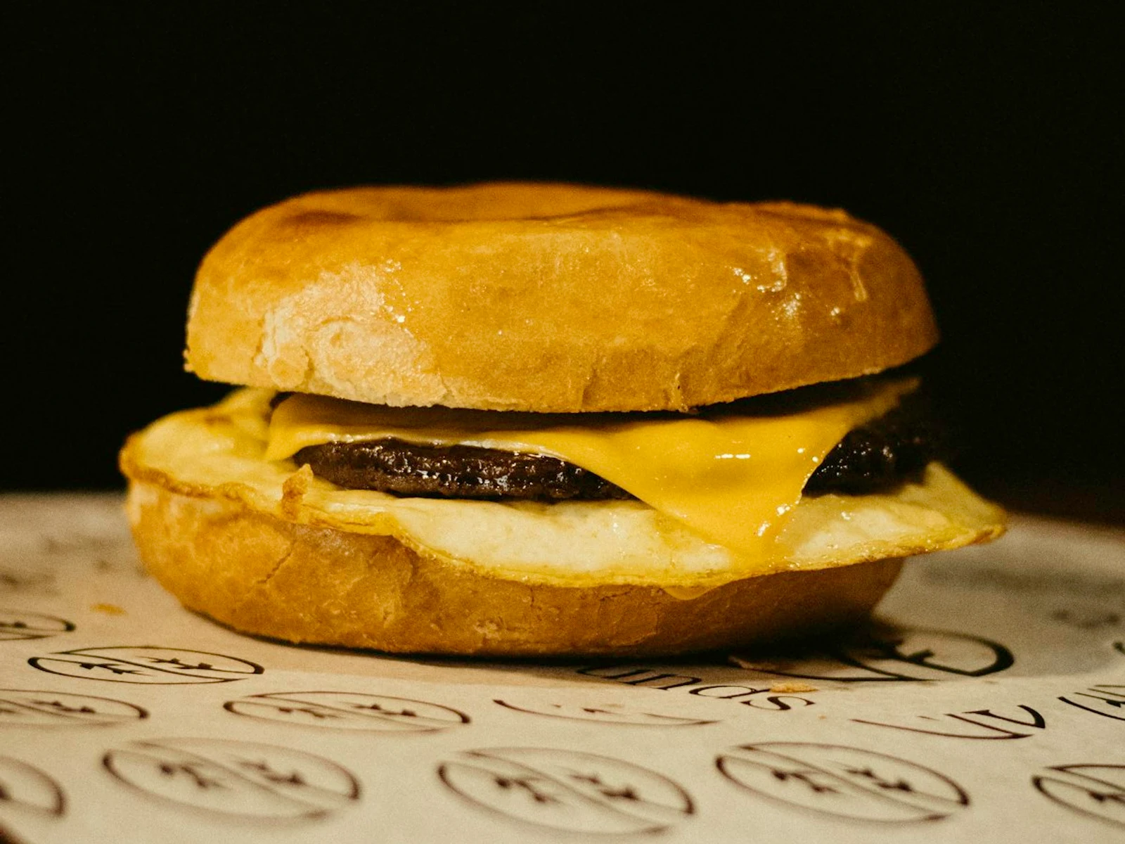 Sausage, egg and cheese on a biscuit on white paper napkins