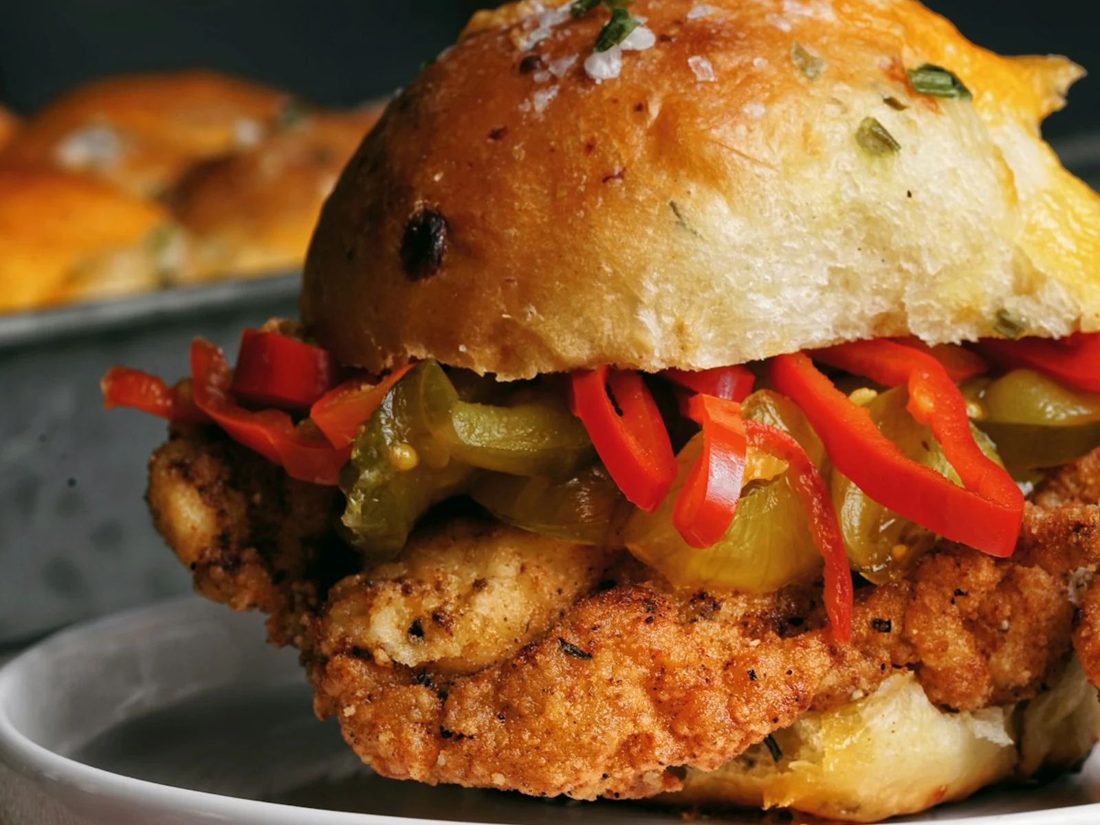 Spicy chicken fillet on a biscuit with the word Spicy in the background