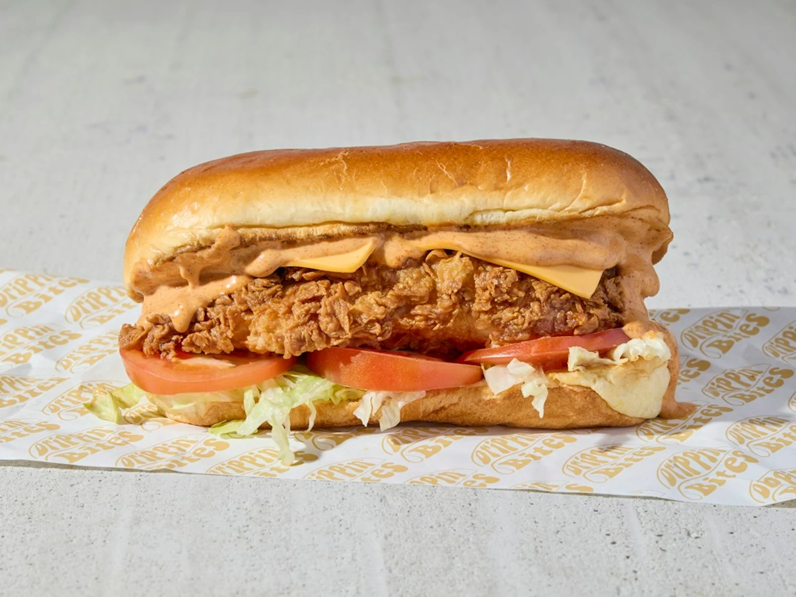 Boneless breast of chicken served on a toasted, buttered bun with dill pickle chips, green leaf lettuce, tomato and American cheese.