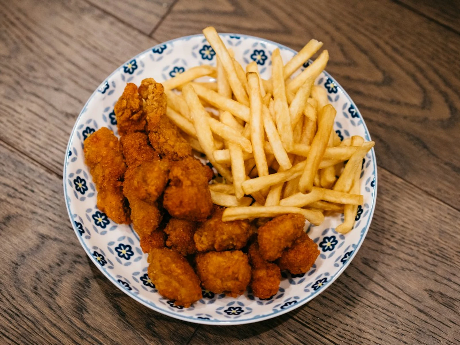 Communal platter of nuggets, waffle fries, and treats for Family Style Meals