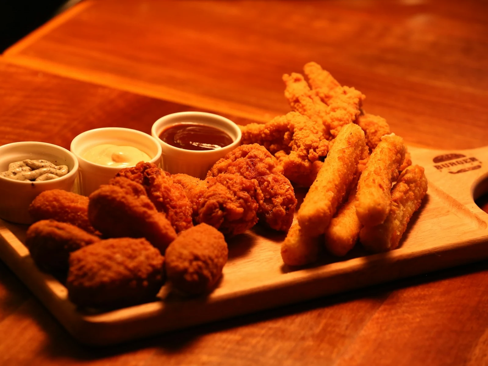 10-count Chick-n-Strips™ on a platter with various stacked sauces